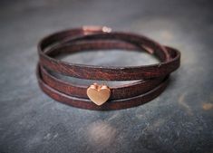 A brown leather wrap bracelet with a beautiful rose-golden heart charm. It comes gift wrapped in a handmade Origami envelope and a colour matching organza pouch. A little handwritten note can be added for that extra personal touch.   It is 5mm wide and 51 - 54cm long (adjustable with a chain extender) The bracelet wraps around the wrist 3 times. The bracelet is made from real leather, can vary in texture and colour and has a nice "vintage effect". Also available in black or tan leather. Beige Bracelet, Origami Envelope, Brown Leather Bracelet, Organza Pouch, Bracelet Heart, Colour Matching, Turquoise Leather, Golden Heart, Cabochon Jewelry