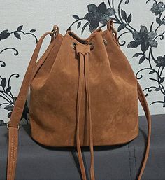 Crossbody Bucket bag, Vegan Suede Bucket Bag, Vegan Leather Bucket Bag for women,  Leather Bag, Handbag, Leather Crossbody Bag, Purse Women Vegan suede and leather crossbody bucket bag with ellipse shaped bottom. The Bucket bags are available in high quality Vegan Suede and in Vegan leather too.  Please note that suede and leather models are a little bit difference:   Suede bucket bags have only NOT DETACHABLE long  adjustable crossbody  strap (NO SHORT HANDLE )  Leather bucket bags have detachable adjustable crossbody strap and short handle. You may find this bag in other colors in vegan suede and in genuine suede too in my shop: https://www.etsy.com/shop/LIONDO?ref=cart_shop_name_click&cart_id=4053747673&section_id=26104071. Its size is ideal for holding your basic necessities such as ph Brown Suede Bag, Vegan Purses, How To Make Brown, Suede Bag, Handbag Leather, Leather Bucket Bag, Leather Bucket, Green Suede, Women Leather