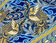 two birds are flying in the sky with blue and gold colors on it's wings