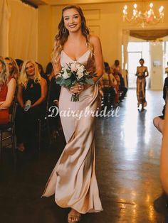 a woman in a long dress walking down the aisle