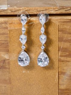 This is the perfect classic earring. An elegant rhinestone earring with a stunning Cubic teardrop that has great movement. These earrings are not vintage but have a vintage look. Great for a bridal party, the bride or a special occasion. A great gift idea. I T E M ∙ S P E C I F I C A T I O N S - EARRING: Total length 1 1/4", top bar 3/4" long, Teardrop is 3/8" x 1/2" - MATERIAL: Costume Earrings with a pierced earring back. Surgical steel post - COLOR: Silver Metal with rhinestone Classic Teardrop Crystal Earrings For Parties, Classic Crystal Teardrop Earrings For Party, Classic Drop Crystal Earrings For Party, Classic Pear-shaped Teardrop Earrings For Party, Classic Crystal Teardrop Earrings, Classic Teardrop Pendant Earrings For Party, Classic Teardrop Earrings With Sparkling Stones, Classic Teardrop Crystal Earrings, Classic Crystal Teardrop Bridal Earrings