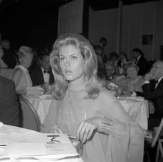 a woman sitting at a table in front of a man