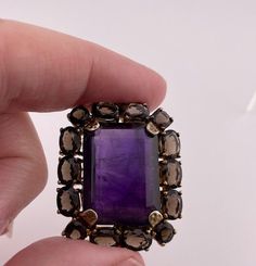 Lovely rare piece of jewelry can be used as a pendent or made into a ring or brooch.  If you look carefully it looks like a slight scratch and a couple of nicks on the amethyst.  The amethyst measures .5" x 3/4" and the total piece measures 1" x 1 & 1/4". Unique Gemstone Pendant Brooch, Antique Jewelry With Gemstone Accents For Formal Occasions, Formal Pendant Jewelry With Large Stone, Elegant Brown Jewelry With Large Stone, Formal Amethyst Jewelry With Large Stone, Formal Large Stone Amethyst Jewelry, Formal Gold Jewelry With Large Stone, Elegant Brown Jewelry With Stones, Collectible Gold Jewelry With Gemstone Accents