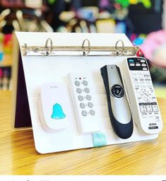 a cell phone and remote control on a desk