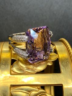 Not all amethyst rings are created equal... obviously. Crafted in 18K white gold, this ring is centered by an approximately 21ct fantasy cut amenthyst which is surrounded by approximately 1.84cttw in pavé set H-I color Si1-i1 clarity round diamonds. An amethyst ring that is bright and full of life! Dimensions/Weight: Ring measures .70" top to bottom and .90" wide and weighs 16g. Condition: All stones are secure and this ring has been freshly polished. The amethyst is chipped in two places on the Luxury Multi-stone Amethyst Ring In White Gold, Luxury Open Amethyst Ring, Luxury Amethyst Open Ring Fine Jewelry, Luxury Hallmarked Diamond Amethyst Ring, Luxury White Gold Multi-stone Amethyst Ring, Luxury Marquise Cut Amethyst Ring, Luxury Open Amethyst Ring Fine Jewelry, Luxury Exquisite Diamond Amethyst Ring, Luxury Marquise Amethyst Ring Fine Jewelry