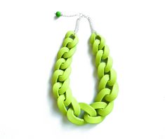 "Oversized chunky chain necklace entirely handmade link by link from polymer clay in apple green finished with silver plated chain. Unique yet versatile statement necklace in neutral shade, ideal for color matching with various outfits. Length: See the drop down menu for options // Modeled necklace is 18 inches (46 cm). All necklaces come with extender for extra 2\" (5-6cm). Lobster clasp closure on the back. Chain links are approx 2 -1 1/2 long inch and smaller in the ends of the necklace and e Trendy Green Chain Link Jewelry, Green Chain Link Necklace With Adjustable Chain, Green Adjustable Chain Link Necklace, Green Necklace With Adjustable Chain, Green Chunky Chain Necklace As Gift, Trendy Green Chain Necklace With Adjustable Chain, Trendy Green Adjustable Chain Necklace, Bold Handmade Green Jewelry, Back Chain