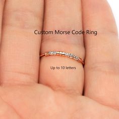 Dainty custom morse code ring with tiny precious metal beads represents dots and dashes. You can personalize ring by choosing a word, name, date, secret, or hidden message. It is great alone or stacked together on a finger or two. Give yourself this gift or to a Friend, Aunt, Sister, Mother, and Grand Mother. The tiny dots and dashes beads are secured to the band with two longer beads at both ends so they do not slide around. [ Band Thickness ]  18 gauge, about 1mm thick. [ Material ] Band - 14K Morse Code Ring, Code Morse, Hidden Message, Morse Code, Secret Messages, Gold Filled Ring, Argentium Silver, Personalized Rings, Small Rings