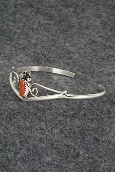 This coral and sterling silver bracelet was made by Navajo silversmith Max Calladitto. The inside is signed C and stamped sterling.Size: 5 1/4" (will fit up to a 6" wrist)Gap: 3/4"Width: 5/8"Free shipping on all orders! We ship with USPS and always include tracking. All orders ship within a day of payment.Returns are accepted up to 30 days after you receive your order. Just send us a message. Our shop offers cash back or store credit. The item must be returned in new condition. Southwestern Sterling Silver Polished Bangle Bracelet, Adjustable Etched Sterling Silver Southwestern Bracelet, Nickel-free Southwestern Sterling Silver Bracelet, Southwestern Silver Hand-strung Bracelets, Southwestern Style Blue Nickel-free Cuff Bracelet, Sterling Silver Bracelet, Native American Jewelry, Free Jewelry, Sterling Silver Bracelets