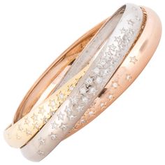 Cartier's 100th Anniversary Trinity bangle with diamonds inset in stars. There are 100 round diamonds totaling 3.50 carats, F-G color and VVS2-VS1 clarity. Marked on the inside of the rose gold bangle "GD 750 Cartier 36855C snoe". Each bracelet measures 3/8 inches wide. Size 20cm Bangle With Diamonds, Cartier Bangle, 100 Year Anniversary, Gold Everything, Cartier Bracelet, Rose Gold Bangle, Bangle Ring, Cartier Jewelry, 100th Anniversary