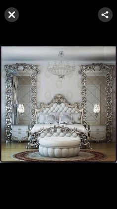 a white bed sitting on top of a wooden floor next to a chandelier