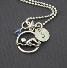 a silver necklace with an initial charm on it