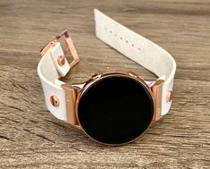 High Quality White Genuine Leather Strap Band Compatible with : Galaxy Watch (42mm) | Galaxy Watch Active | Watch Active2 (40mm) | Watch Active2 (44mm) | Adjustable Size Bracelet Perfectly Tailored to Fit Your Wrist. Designed And Handmade by Simeon D Jewelry. The Bracelet is Super Easy to Install on Your Watch. Comes with 4pcs 20mm Quick Release Pins. Please Measure Your Wrist Before Submitting Your Order! Samsung Watch Is NOT Included Create Your Own Unique Style! Be Different! Be Unique! Make Rose Gold Watch Bands As Gift, White Leather Strap Watch Bands For Gift, Adjustable Rose Gold Watches With Leather Strap, White Leather Strap Watch Band As Gift, Rose Gold Bracelet Strap Watch Accessories, Rose Gold Round Bracelet Strap Watch Accessories, Rose Gold Round Watch With Bracelet Strap, Round Rose Gold Watch Accessories As Gift, White Round Watch Accessories For Gift