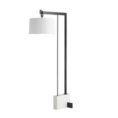 a black and white floor lamp with a square shade on the top, next to a rectangular light fixture