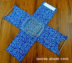 a piece of blue fabric sitting on top of a wooden floor