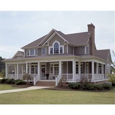 a large house sitting on top of a lush green field