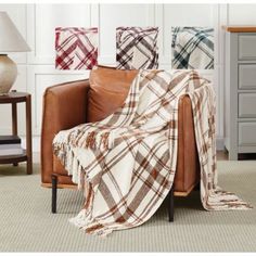 a plaid blanket sitting on top of a leather chair