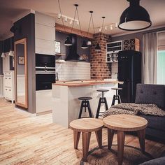 an open concept kitchen and living room with wood flooring