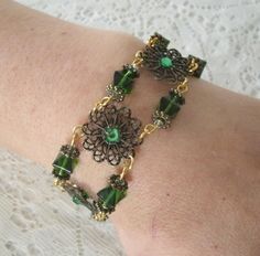 "This beautiful bracelet has seed beads, green Czech glass beads, antique gold accent beads and antique gold filigree settings accented with rhinestones. 7\" long. Toggle clasp." Antique Gold Beaded Jewelry With Round Beads, Nickel Free Czech Glass Wedding Jewelry, Ornate Nickel-free Bronze Jewelry, Elegant Antique Gold Brass Bracelet, Bronze Ornate Nickel-free Jewelry, Vintage Metal Jewelry With Round Beads, Vintage Handmade Jewelry With Round Beads, Nickel-free Bronze Bracelet Jewelry, Ornate Nickel-free Bracelet Jewelry