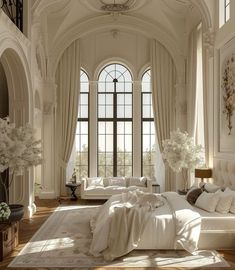 an elegant bedroom with white furniture and large windows