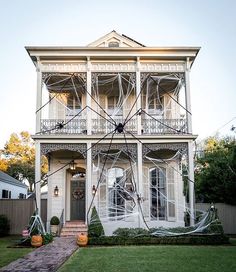 a white house with spider webs on the front