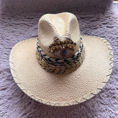 Size: 6 7/8-7" or 55cm Small  Handcrafted by Colombian artisans and accented with assorted adornments, these embellished natural straw hats are wearable art accessories perfect for trail riding, beach going or traveling. Each hat is unique some of the charms or fringes may vary slightly from the picture. 100% Straw.  tags: Gypsi Straw natural tone Handwoven artisan artesanos colombianos Coachella Festival festivals spring summer vacation beach cos lollapalooza miami burning man college exotic feather western native firefly unique gift gifts Jewled Cowgirl Hat Staple accessory for line dances, music festivals, or even just a fashion statement gypsies romanian DECORATED summer Evil eye boho bohemian Gold Wide Brim Bohemian Fedora, Handmade Gold Summer Hats, Gold Wide Brim Fedora For Beach, Gold Festival Hat Bands For Summer, Gold Bohemian Hat For Kentucky Derby, Bohemian Gold Hat For Kentucky Derby, Bohemian Gold Straw Hat For Vacation, Gold Bohemian Straw Hat For Vacation, Gold Bohemian Brimmed Hat