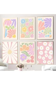 four flower prints are hanging on the wall