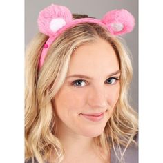 a woman with blonde hair wearing a pink bunny ears headband