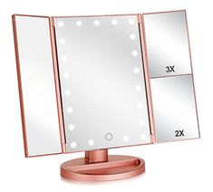 a pink lighted vanity mirror sitting on top of a table