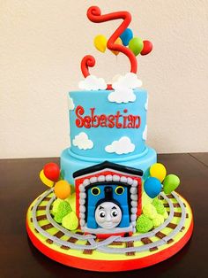 a thomas the train birthday cake on a table