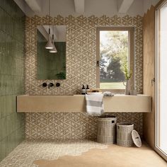 a bathroom with a sink, mirror and two baskets on the floor in front of it