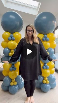 a woman is standing in front of balloons