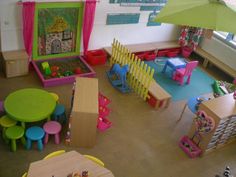 a child's playroom with tables, chairs and other toys on the floor