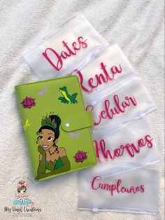 three personalized disney princess wallets on a bed