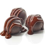 three pieces of chocolate covered in melted chocolate