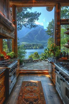 a kitchen with an open door leading to a lake and mountains in the back ground