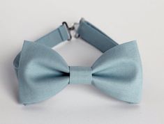 This trendy and stylish bow tie is great for so many occasions!Bow tie made of cotton fabric with a matching, adjustable neck strap. Style:• The Pre-Tied Bow Tie (with an adjustable neck strap)• The Clip-On Bow Tie (strapless, just a clip that you attach to the shirt collar)• Pocket square (handkerchief) All our bow ties can be made in the following sizes, just specify which size you need in a note at checkout: Sizes:Baby: 3.5" x 2"Kids: 4" x 2"Youth:  4.5" x 2.25Adult: 5" x 2.5"All our bow ties Blue Bow With Bow Tie Back For Wedding, Blue Bow Tie With Bow Tie Back For Weddings, Blue Bow Tie For Wedding, Blue Wedding Bow Tie With Bow Tie Back, Blue Bow Tie With Bow Tie Back For Groom, Blue Satin Bow Tie For Weddings, Dapper Blue Bow Tie For Groom, Classic Blue Bow Tie For Wedding, Classic Blue Bow Tie For Groom