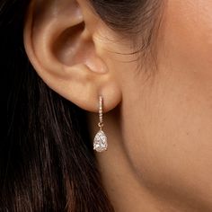 Simply elegant, and absolutely gorgeous. Welcome these timeless diamond dangle earrings into your life! We make our pear cut diamond drop, diamond huggie hoop earrings in your choice of 18k gold (rose, yellow, or black, or white upon request). Here, in 18k rose gold. 18k rose gold pear cut diamond drop earring on diamond-faced hinged huggie hoops. 2.12cts (pair) of white diamonds. F color, VS1 clarity 18k rose gold hardware. Diamond-faced hinged huggie hoop earwires with hidden closure. Lovingly Luxury Diamond Cut Drop Huggie Earrings, Luxury Formal Huggie Earrings, Luxury Teardrop Diamond Earrings With Brilliant Cut, Luxury Dazzling Huggie Earrings With Diamond Accents, Luxury Dainty Huggie Earrings With Diamond Accents, Timeless Luxury Huggie Earrings For Anniversary, Elegant Luxury Huggie Earrings With Prong Setting, Luxury Dangle Huggie Earrings With Prong Setting, Luxury Diamond Drop Earrings With Pave Setting