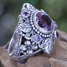 Faceted and polished amethyst crowns this elegant ring. Kadek Hendra works in sterling silver and amethysts totaling 3.4 carats. The handcrafted design reveals its Balinese origin with luscious flower and plant motifs. .925 Sterling silver Amethyst Flower, Bohemian Rings, Purple Crystals, Crystal Flower, Amethyst Stone, Flower Ring, Crystal Rings, Ring Vintage, Amethyst Ring