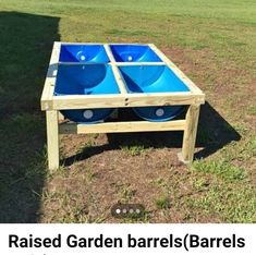 raised garden barrel with two blue bowls on the bottom and one in the middle for storage