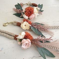 three flowers and feathers are tied to rope