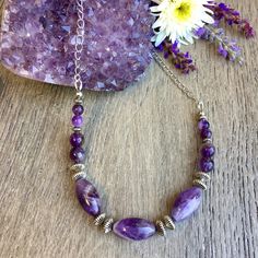 "You'll love this AMETHYST & SILVER NECKLACE!  It's made with three different amethyst bead sizes including 6mm and 8mm round, 10mm x 18mm rice/tube shapes, and completed with silver plated accent beads, silver chain and clasp.  The stones are slightly different in each necklace, but all are equally beautiful!   Available in chain lengths 16\", 18\", and 24\".  A beautiful natural stone necklace to wear alone or paired with others.  Each jewelry item arrives to you in a gift box, made from recyc Lavender Amethyst Necklace With Stones, Lavender Amethyst Necklaces For Jewelry Making, Purple Crystal Necklaces With Faceted Beads For Healing, Healing Amethyst Beaded Necklaces With Polished Beads, Healing Amethyst Beaded Necklace With Polished Beads, Healing Purple Crystal Necklaces With Faceted Beads, Spiritual Amethyst Necklace With Faceted Beads, Healing Purple Crystal Necklace With Faceted Beads, Amethyst Crystal Necklace For Healing