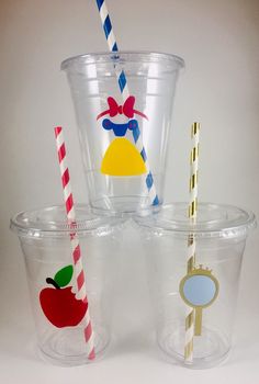 three plastic cups with straws in them