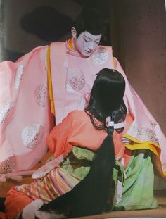 an old photo of two women dressed in traditional japanese clothing