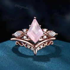 a rose quartz ring with diamonds on it