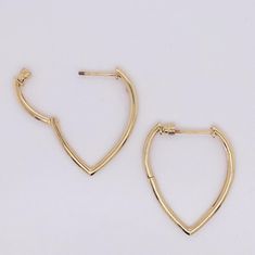 Show your stylish flair with this contemporary twist on classic hoop earrings! Vibrant contrast shines in the rounded hoop top that flares out then slims down into a rounded point to form an inverted droplet or pear shape. The cleanly bright solid 14 karat yellow gold look can be casual to elegant depending on how you want to dress! The "screwback" threaded posts and backs on these hoops are a fabulous secure upgrade to the standard post options for hoops. Just like the security some people love Teardrop Hoop Earrings With Polished Finish For Formal Occasions, Teardrop Hoop Earrings With Polished Finish For Formal Events, Classic Teardrop Hoop Earrings, Modern Pear-shaped Earrings, Formal Teardrop Huggie Earrings With Polished Finish, Modern Teardrop Huggie Earrings With Polished Finish, Modern Teardrop Single Huggie Earring, Classic Teardrop Single Hoop Earring, Formal Teardrop Hoop Earrings