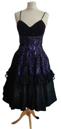 A fabulous party dress by Caroline Walker of London Dance the night away in this stunning gown   This fit and flare dress is black velvet lace & satin, The bodice is boned with a sweetheart neckline.  Fitted  waist and the most wonderfully full skirt with layers and layers of purple tulle, the colour purple looks absolutely stunning underneath the Lace  This is a truly Elegant beautiful dress Excellent condition Victorian Ball Gown With Fitted Bodice For Parties, Vintage Victorian Dress For Halloween Party, Halloween Velvet Party Dress, Vintage Victorian Dress For Halloween Evening, Velvet Evening Dress For Halloween, Gothic Victorian Dress With Fitted Bodice For Party, Vintage Corset Back Dress For Party, Vintage Corset Dress For Party, Vintage Overbust Dress For Party