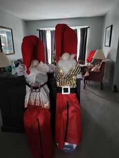 two santa clauss sitting on top of each other