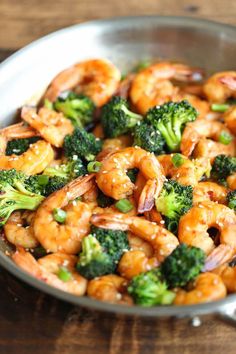 shrimp and broccoli in a skillet with sesame seeds