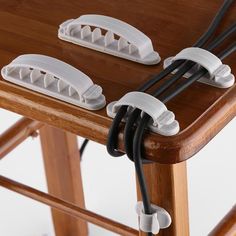 two chairs with cords connected to them on top of a wooden table