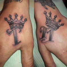 two hands that have tattoos on them, one with a crown and the other with a letter